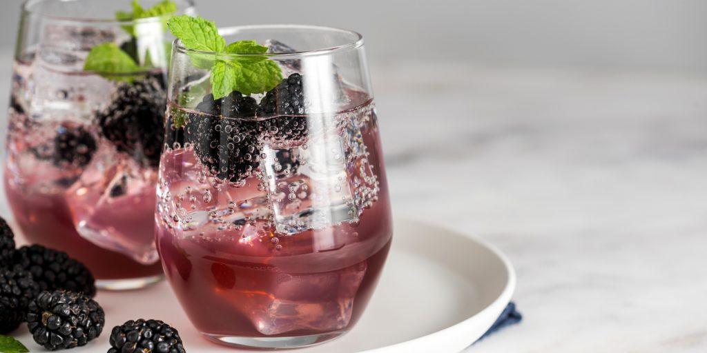 Two Shrub cocktails with blackberries