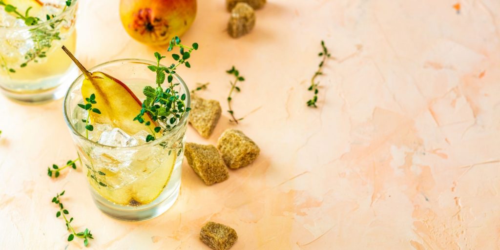 A gorgeous Falling Leaves cocktail  garnished with thyme to bring out the pear notes