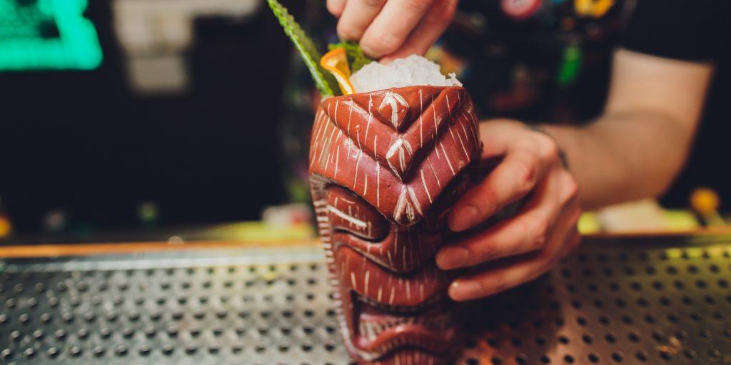 Barman garnishing tiki cocktail