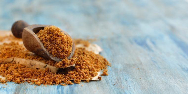 Brown sugar on a wooden spoon