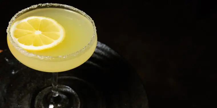 A Mad Hatter cocktail garnished with lemon