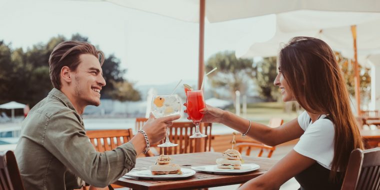 A couple clinking cocktails together on Valentines Day