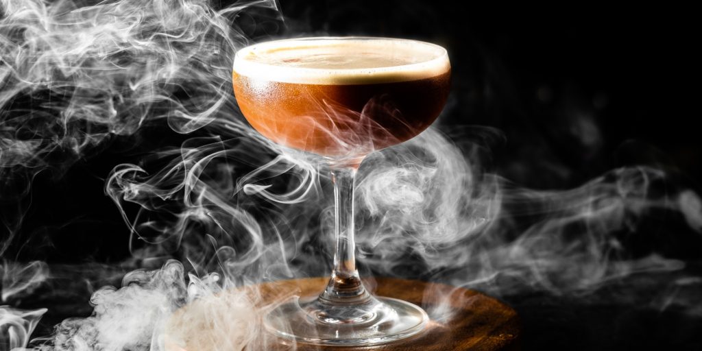 Close-up of a chocolate cocktail with smoke swirling around it.