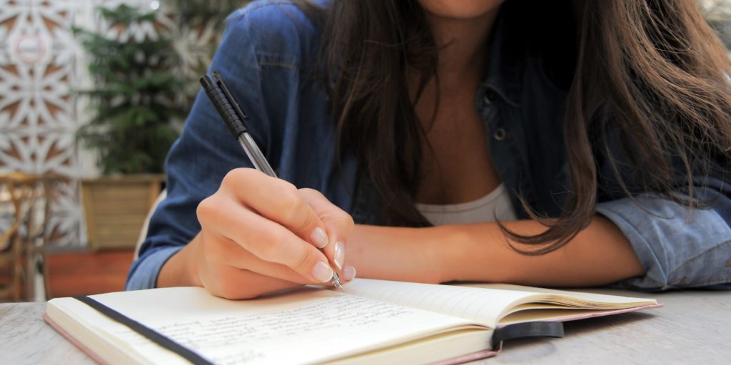 A lady writing in her journal 