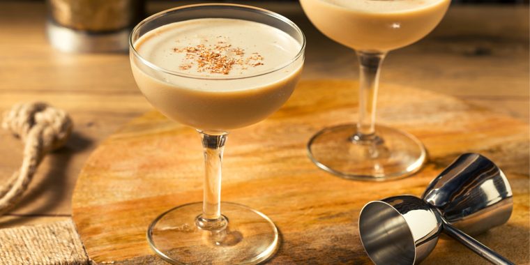 Creamy Golden Cadillac cocktails in coupe glasses served with a sprinkling of nutmeg