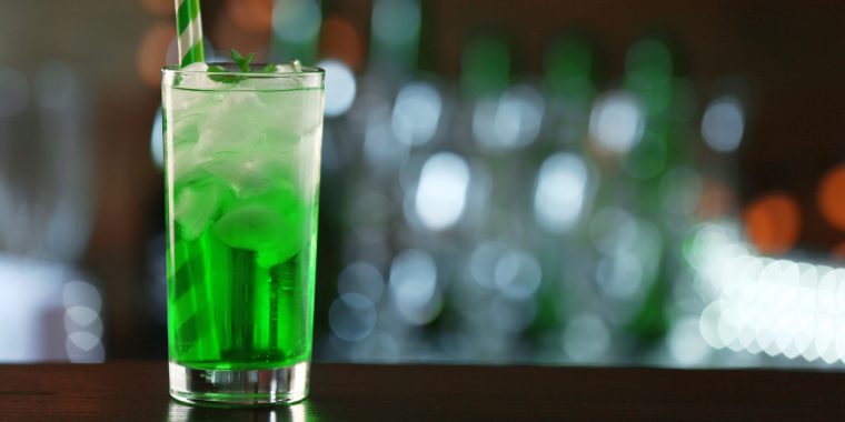 Green Hornet cocktail in a highball glass with ice