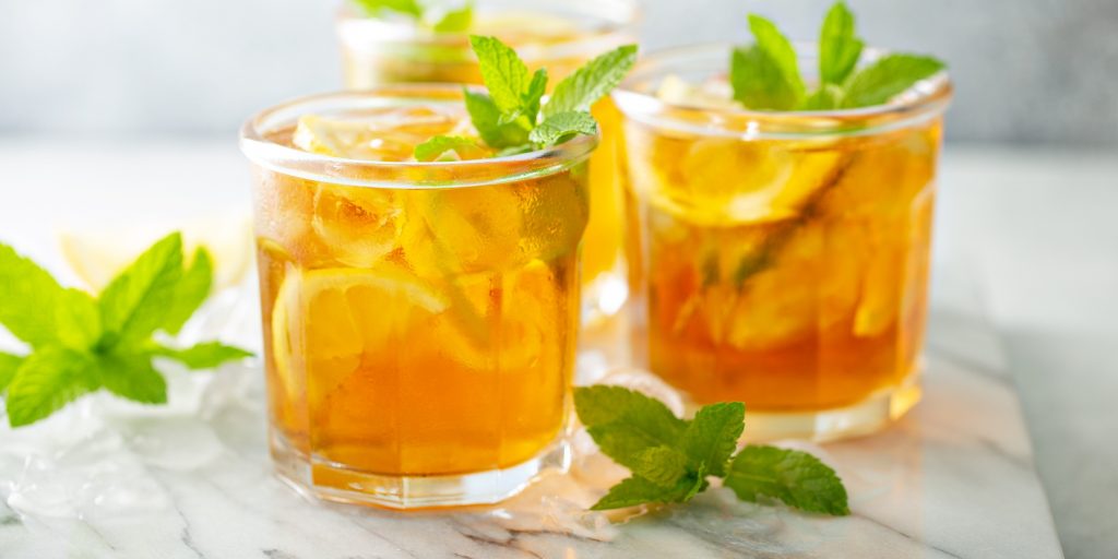 Three Vodka Iced Tea cocktails in tumblers with lemon and mint garnish