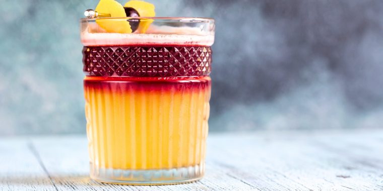 New York Sour cocktail with a lemon twist and cherry garnish