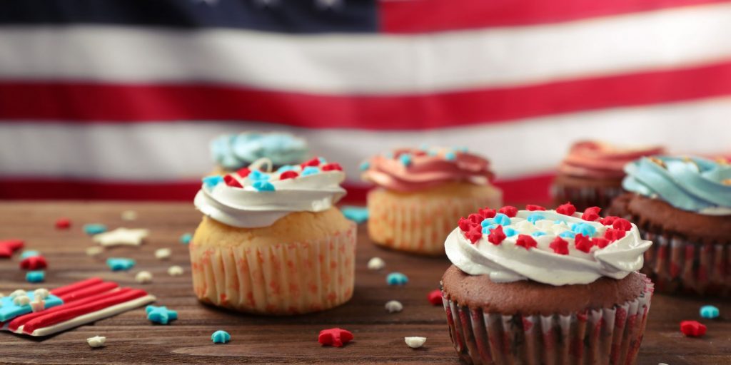 Close up of a collection of cupcakes iced in American flag colors for a Memorial Day party at home