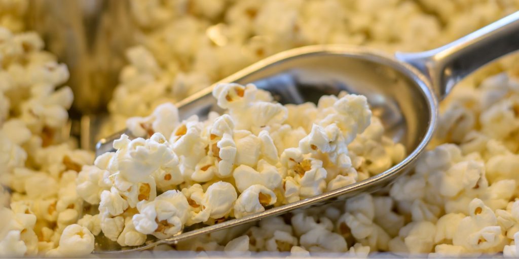 Popcorn in a popcorn scoop on a bar cart with a twist