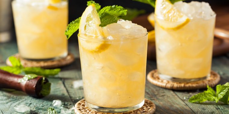 Classic Whiskey Smash cocktails with lemon and mint garnish