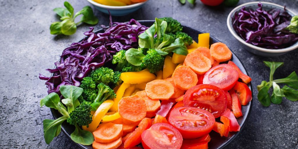 Rainbow colored salad platter artfully arranged for a Pride Party