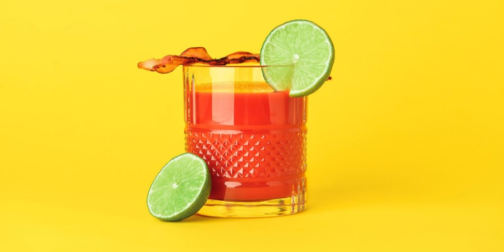 Bacon Bloody Mary against a retro yellow backdrop