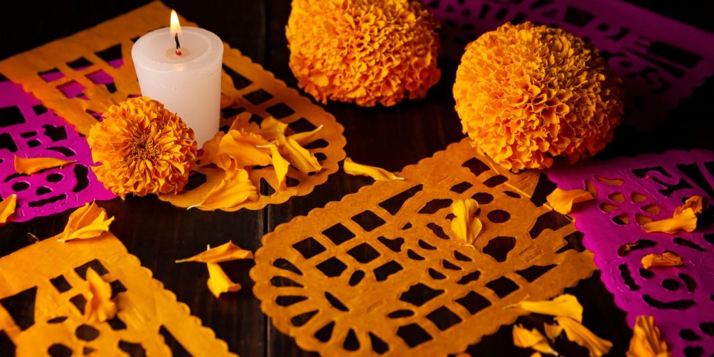 Close up of cut paper decorations to be used as a part of Dia de los Muertos party invitations