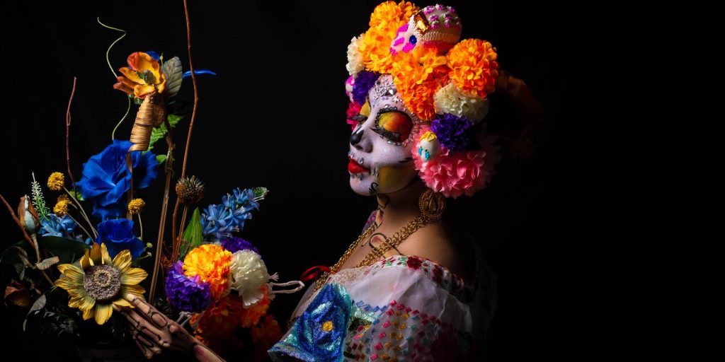 Close up of a woman dressed supmptuously for a Dia de los Muertos celebration