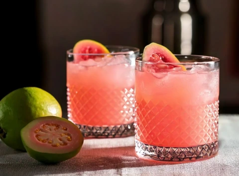 Two Guava Mezcal Margaritas with fresh Guava garnish