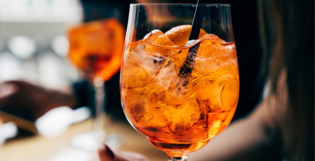 A close up shot of an Aperol spritz cocktail.